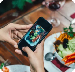 A phone taking a photo of a meal