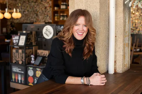 A photo of a woman laughing and smiling, Tracy, your dining companion